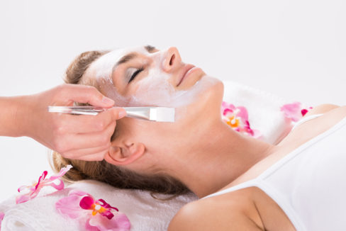 beautician-applying-mask-on-customers-face-at-salon